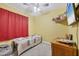 This charming bedroom with yellow walls features a twin bed, a ceiling fan, and playful decor at 2034 Mesic Hammock Way, Venice, FL 34292
