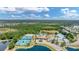 Aerial view of community amenities including tennis courts, pools, and lush landscaping for active lifestyles at 2034 Mesic Hammock Way, Venice, FL 34292