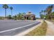 Gated community entrance with a beautifully designed gatehouse and palm tree lined streets at 2034 Mesic Hammock Way, Venice, FL 34292