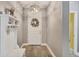 Bright foyer featuring hardwood floors, a decorative wreath, and a hall tree with coat hooks at 2034 Mesic Hammock Way, Venice, FL 34292