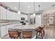 Modern kitchen with granite countertops, stainless steel appliances, and a breakfast bar with seating at 2034 Mesic Hammock Way, Venice, FL 34292