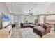 Spacious living room featuring hardwood floors, a large sectional sofa, and sliding glass doors at 2034 Mesic Hammock Way, Venice, FL 34292