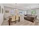 Open living and dining space with hardwood floors and bright natural lighting at 2034 Mesic Hammock Way, Venice, FL 34292