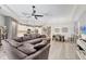 Bright living area flowing into the kitchen, featuring hardwood floors, a sectional sofa, and a dining area at 2034 Mesic Hammock Way, Venice, FL 34292