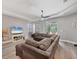 Inviting living room with hardwood floors, a sectional sofa, and a sliding door to the outdoor patio at 2034 Mesic Hammock Way, Venice, FL 34292
