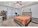 Spacious main bedroom featuring tray ceilings, a ceiling fan, and carpet flooring at 2034 Mesic Hammock Way, Venice, FL 34292