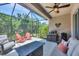 Outdoor patio with outdoor seating, a fire pit, and views of the lush green backyard at 2034 Mesic Hammock Way, Venice, FL 34292