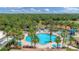 Beautiful community pool surrounded by lush greenery and palm trees for a tropical experience at 2034 Mesic Hammock Way, Venice, FL 34292