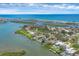 Aerial view showcasing waterfront homes, lush landscapes, and the serene beauty of a coastal community at 205 Louella Ln, Nokomis, FL 34275