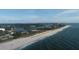 Stunning aerial view showcasing the coastline, white sandy beach, and clear ocean waters at 205 Louella Ln, Nokomis, FL 34275