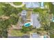 Aerial view of a stunning property with a pool, lush landscaping, and waterfront access, showcasing luxury living at 205 Louella Ln, Nokomis, FL 34275