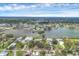 Panoramic aerial view of waterfront homes and community with lush landscaping, and a beautiful blue sky at 205 Louella Ln, Nokomis, FL 34275
