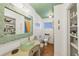 Quaint bathroom with bowl sink, updated finishes, storage and tiled floors at 205 Louella Ln, Nokomis, FL 34275