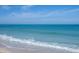 A serene beach scene with gentle waves lapping onto the shore, creating a relaxing atmosphere at 205 Louella Ln, Nokomis, FL 34275