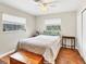 Comfortable bedroom featuring wood floors, a ceiling fan, natural light, and closet for storage at 205 Louella Ln, Nokomis, FL 34275