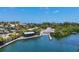 Boat ramp featuring a covered dock and clear water access, ideal for boating and water activities at 205 Louella Ln, Nokomis, FL 34275