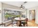 Bright breakfast nook with wood floors and views of backyard and waterfront at 205 Louella Ln, Nokomis, FL 34275