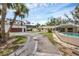 Exterior showcasing a well-maintained home, a pool, a spacious driveway, and lush landscaping, inviting and perfect for outdoor enjoyment at 205 Louella Ln, Nokomis, FL 34275