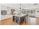Open kitchen with a large island, stainless steel appliances, and ample cabinetry, a perfect blend of style and functionality at 205 Louella Ln, Nokomis, FL 34275