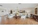 Bright living room featuring wood-look floors, neutral decor, and stylish furnishings, offering a comfortable and inviting space at 205 Louella Ln, Nokomis, FL 34275