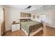 Spacious main bedroom with wood floors and ceiling fan at 205 Louella Ln, Nokomis, FL 34275