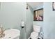 Charming half-bathroom with a toilet and sink, adorned with stylish décor at 205 Louella Ln, Nokomis, FL 34275