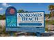 Nokomis Beach sign welcomes visitors, highlighting the area's natural beauty and recreational offerings at 205 Louella Ln, Nokomis, FL 34275