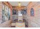Unique tasting room with wine barrel table and display shelving with brick accent wall at 205 Louella Ln, Nokomis, FL 34275