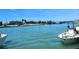 Picturesque waterfront scene featuring boats, a clear waterway, and tropical vegetation at 205 Louella Ln, Nokomis, FL 34275
