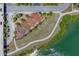 Aerial view of the community showing the tile roofs, water access, sidewalks, and green surroundings at 209 E Venice Ave, Venice, FL 34285