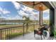 Balcony with seating, overlooking a scenic water view on a clear, sunny day at 209 E Venice Ave, Venice, FL 34285