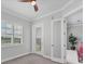 Bright bedroom with neutral walls, carpet, balcony access, and ensuite at 209 E Venice Ave, Venice, FL 34285