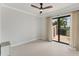 Bedroom with a sliding glass door to a patio and a dark-stained ceiling fan at 209 E Venice Ave, Venice, FL 34285
