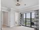 Bedroom with balcony, neutral walls, carpet and decorative curtains at 209 E Venice Ave, Venice, FL 34285