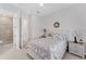 Bedroom with a white ceiling fan, neutral carpet, and side tables with lamps at 209 E Venice Ave, Venice, FL 34285