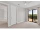 Bedroom showing the closet and access to the carpeted floors and balcony with sliding glass doors at 209 E Venice Ave, Venice, FL 34285