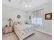 Bedroom with a white ceiling fan, neutral carpet, and side tables with lamps at 209 E Venice Ave, Venice, FL 34285