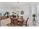 Elegant dining area with decorative chandelier and natural lighting at 209 E Venice Ave, Venice, FL 34285