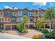 Beautiful townhouse exterior with brick driveway, stone accents, and mature palm trees at 209 E Venice Ave, Venice, FL 34285