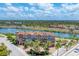 Exterior view of the townhome showcasing landscaping, a private garage and waterfront location at 209 E Venice Ave, Venice, FL 34285