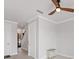 Hallway with neutral tile flooring and white doors, featuring a glimpse of the staircase at 209 E Venice Ave, Venice, FL 34285