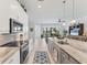 Modern kitchen with stainless appliances, large island, and view to lanai at 209 E Venice Ave, Venice, FL 34285