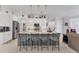 Open kitchen with large island, stainless appliances, and sleek barstool seating at 209 E Venice Ave, Venice, FL 34285