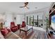 Relaxing living room featuring a ceiling fan, water view from balcony, comfortable seating and a stylish rug at 209 E Venice Ave, Venice, FL 34285