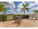 Outdoor patio featuring pavers, iron fence, dining table and chairs, and lounge chairs at 209 E Venice Ave, Venice, FL 34285