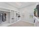 Spacious walk-in closet featuring custom shelving, carpet flooring, and natural light from two windows at 209 E Venice Ave, Venice, FL 34285