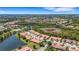 Scenic aerial view of a residential community showcasing beautiful landscaping, ponds, and well-maintained homes at 2104 Batello Dr, Venice, FL 34292