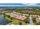 Stunning aerial view of a residential area featuring well-kept homes, green spaces, and tranquil lakes at 2104 Batello Dr, Venice, FL 34292