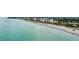 Beautiful aerial view showcasing a scenic shoreline with beachfront properties and clear turquoise waters at 2104 Batello Dr, Venice, FL 34292