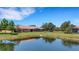 Beautiful backyard view with a pond, lush green grass, and serene landscaping at 2104 Batello Dr, Venice, FL 34292